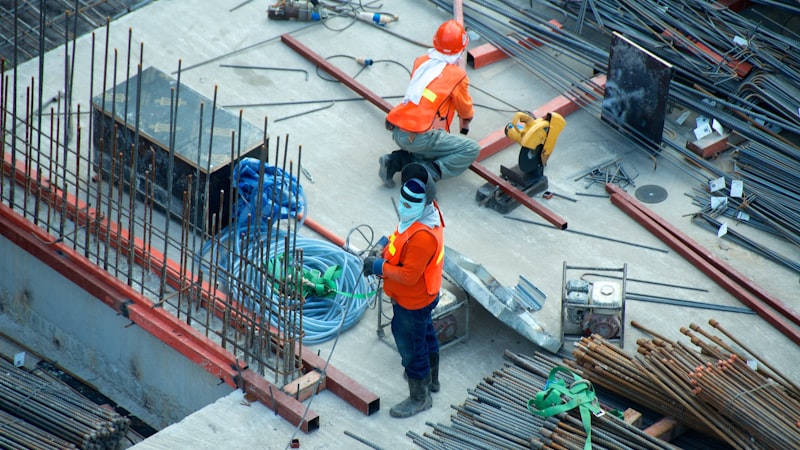 Construction workers reviewing plans on a job site